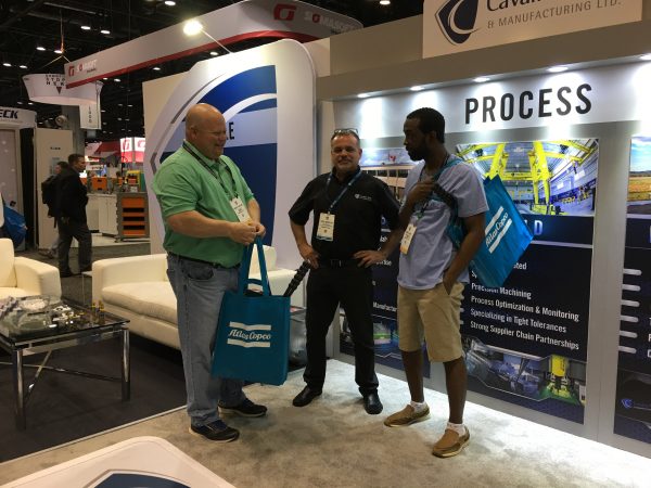 Cavalier Tool Sales Account Manager Todd Shepley stands with unidentified gentlemen at NPE 2018. 