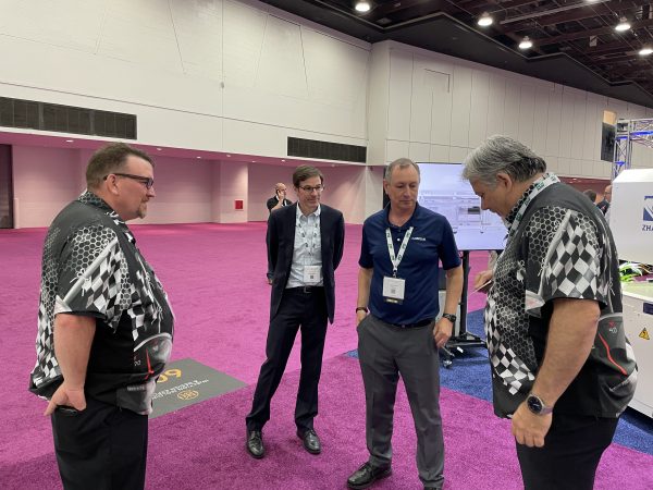 Cavalier Tool's Estimating Manager Brian Gignac and Sales Manager Tim Galbraith are pictured here talking to each other in Cavalier Tool's booth at the Injection Molding and Design Expo.