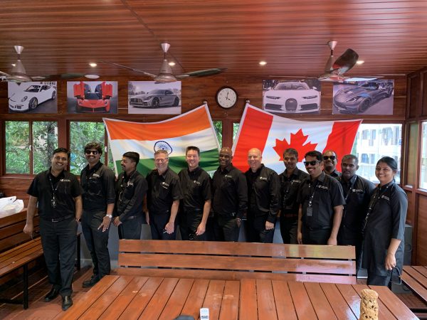 Cavalier Tool India Staff took Brian, Larry, and Chris to a local Indian restaurant. There is an Indian Flag and a Canadian Flag hanging in the background.